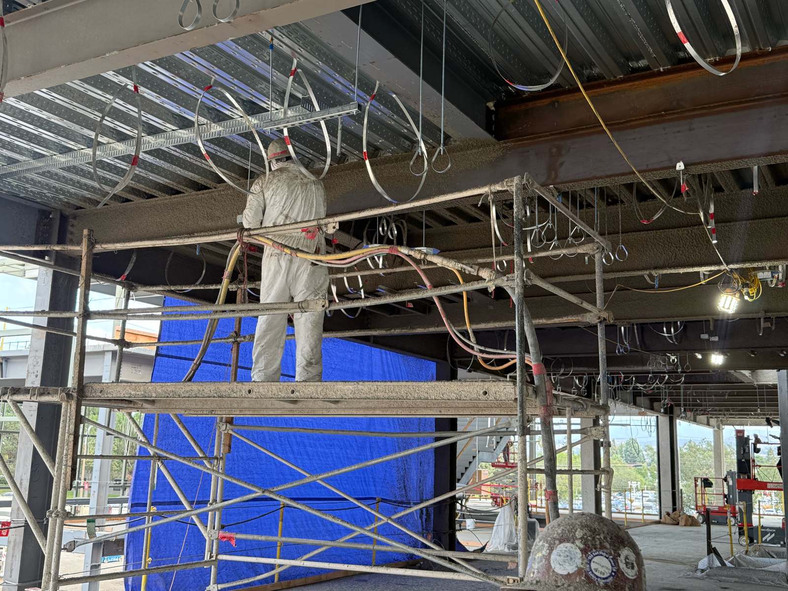 Spray-applied fireproofing on structural steel beams